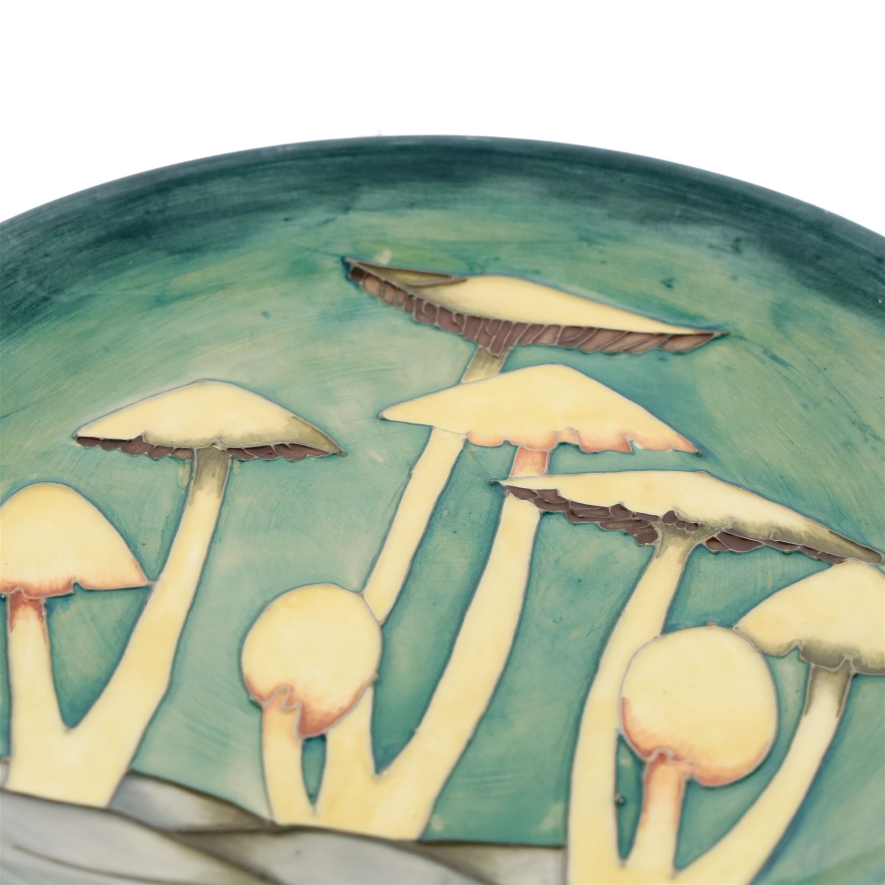 Moorcroft Fairy Ring plate, 1990, decorated with mushrooms upon a green ground, with painted and impressed marks beneath, D26cm