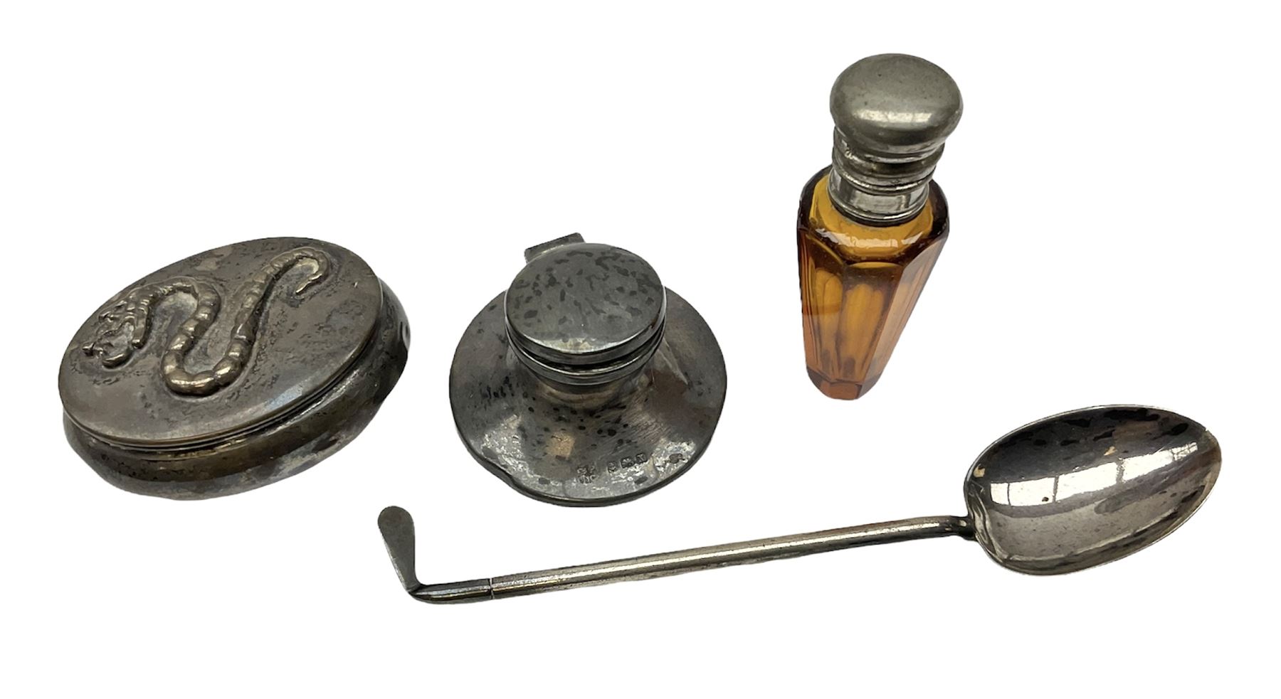 German silver pill box of oval form, the cover decorated with a serpent, stamped with crown and crescent and marked 800, together with a miniature silver capstan inkwell with glass liner, hallmarked Birmingham, a novelty silver teaspoon with golf club terminal, hallmarked Birmingham, and an amber glass scent bottle with silver plated cover, approximate weighable silver (not including inkwell or scent bottle with silver plated cover) 41.9 grams