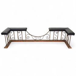 Early 20th-century Arts & Crafts copper club fender, of long serpentine form, scrolling uprights and a shaped centre support, the top rail fitted with four upholstered padded seat sections, raised on a stepped plinth base, inner dimensions 192x43cm 