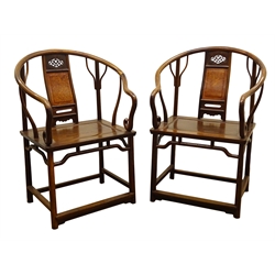  Pair of Huanghuali type horseshoe back open arm chairs, pierced and figured panel splats with solid seats on shaped supports with stretchers, (2)  