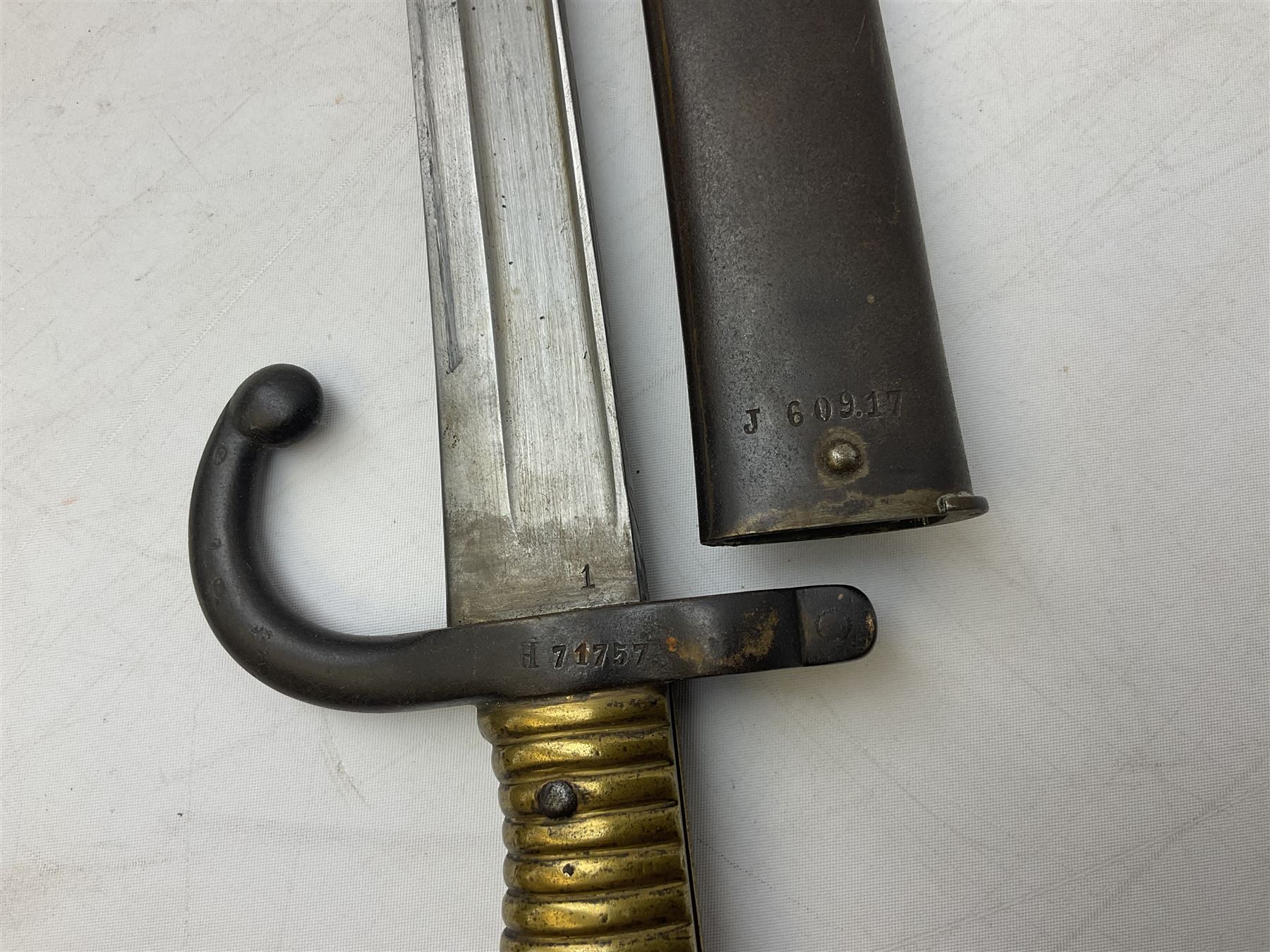 French model 1866 sabre bayonet, the 57.5cm curving blade marked St. Etienne 1868; in associated steel scabbard L71cm overall