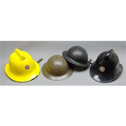  North Riding Fire Brigade Helmet, black with red and silver badge, stamped NP with liner and chinstrap, a North Yorkshire Fire Brigade Helmet, yellow with red and silver badge, stamped Small upto 67/8 1972 with liner and chinstrap, a WWll Fire Helmet and a WWll green tin helmet stamped R.O.Co. 9, 4   
