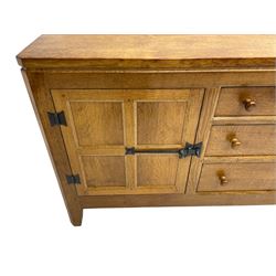 Rabbitman - adzed oak sideboard, fitted with three central drawer and two flanking cupboards, panelled doors with iron latches and hinges, carved with rabbit signature, by Peter Heap, Wetwang