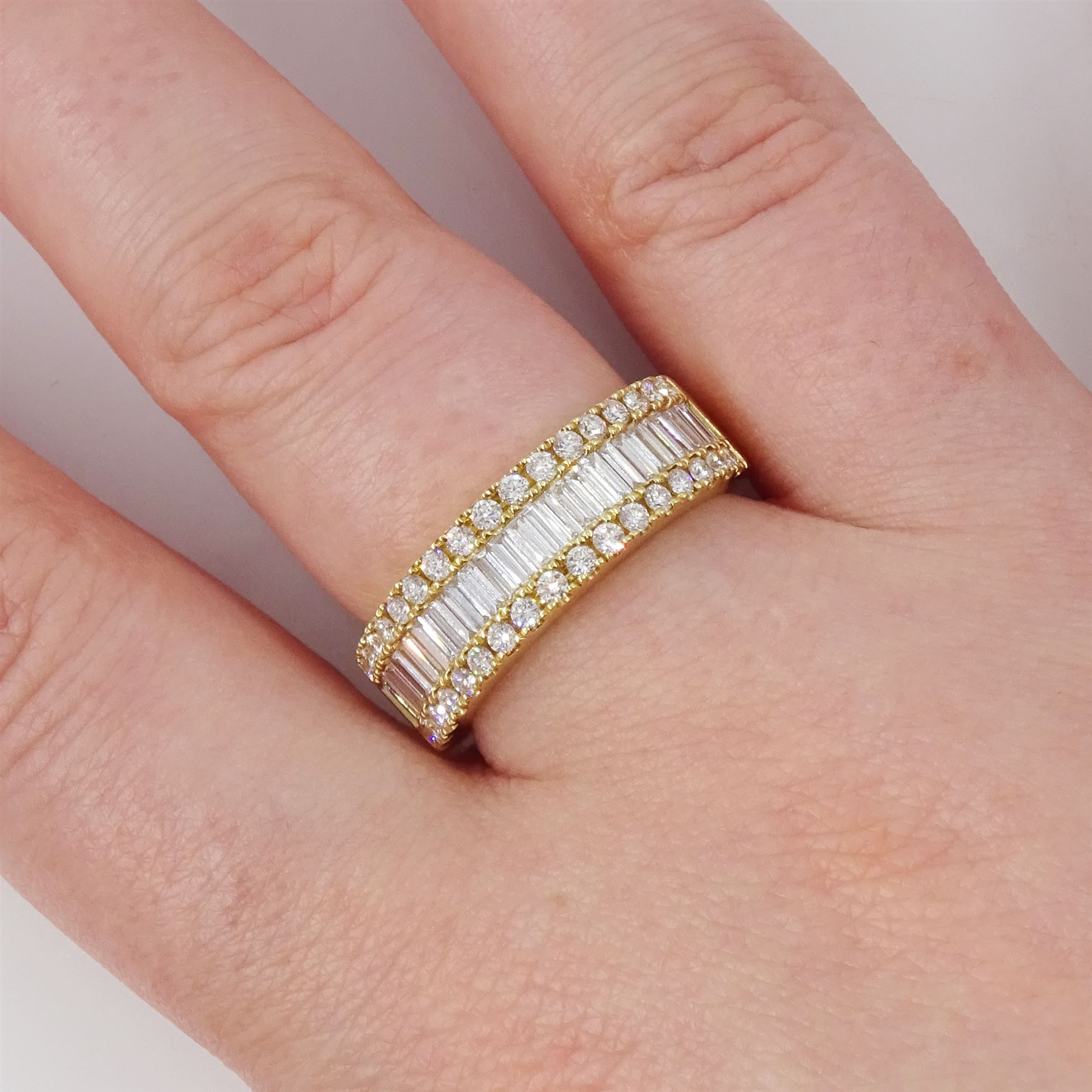 18ct gold diamond three row half eternity ring, single row of baguette cut diamonds, with round brilliant cut diamonds set either side, stamped 750, total diamond weight approx 3.00 carat
