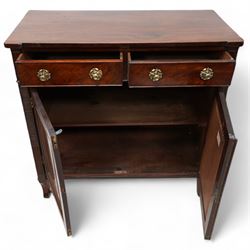 Regency mahogany cupboard, rectangular shaped top over two cock-beaded frieze drawers, fitted with brass Yorkshire rose pull handles, over two panelled and cross-banded cupboards, flanked by reeded uprights, raised on curved feet