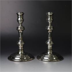 Pair of silver candlesticks, with knopped stems and upon spreading circular weighted bases...