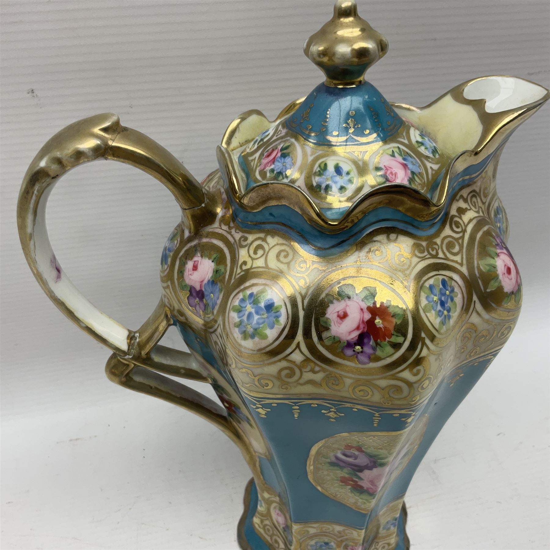 Noritake coffee service, hand painted with roses and gilt detail on a blue ground, comrosing coffee pot, five cups and saucers