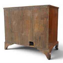 George II figured walnut kneehole desk, the rectangular book-matched veneer top with feather and cross-banding, fitted with single frieze drawer over a short drawer and central recessed cupboard, flanked by three drawers to each side, lower moulded edge on bracket feet