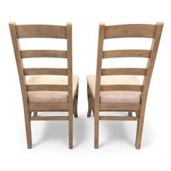 Barker and Stonehouse Flag Stone extending dining table and four matching chairs, the rectangular top with parquetry inlay and contrasting border, extending by central leaf, on slightly curved supports, the chairs with padded upholstered seats and ladder backs (Chairs H 108cm, W 50cm, D 54cm) (Extends to 195cm)