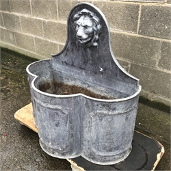 Early 20th century lead fountain, raised shaped back with moulded lions head spout, W74cm, H77cm, D40cm