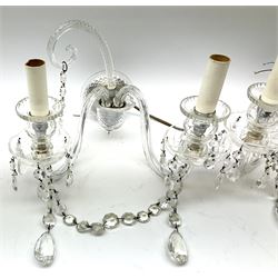 Pair of glass wall sconces, with central curved branch, and two further branches leading to glass sockets and drip pans, each supporting cut glass drops, H25cm L33cm D26cm