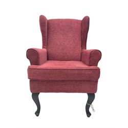 Wingback armchair upholstered in red fabric
