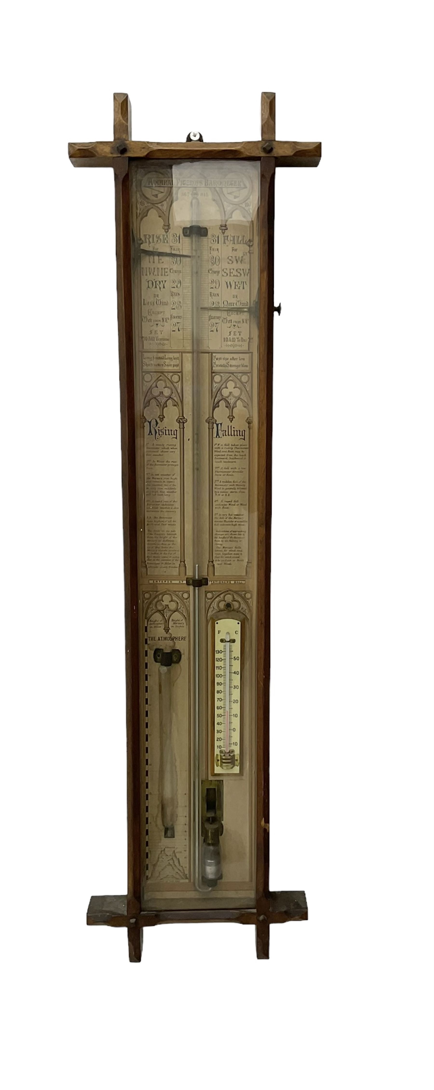 Oak cased Admiral Fitzroy barometer c1890 - with original full height paper scales annotated with Fitzroy's remarks and observations, brass sliding pointers above a Fahrenheit and centigrade spirit thermometer and storm glass, large bore bulb cistern tube with a mechanical sealing tap, in a fully glazed reformed gothic influenced case with chamfered moulded uprights, top, and base.