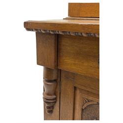 Late 19th century pine dresser, the projecting cornice with dentil and spindle moulded frieze above a three-tier plate shelves, flanked by glazed doors, the base fitted with three frieze drawers over arched apron and carved floral panelled cupboard doors, raised on turned feet