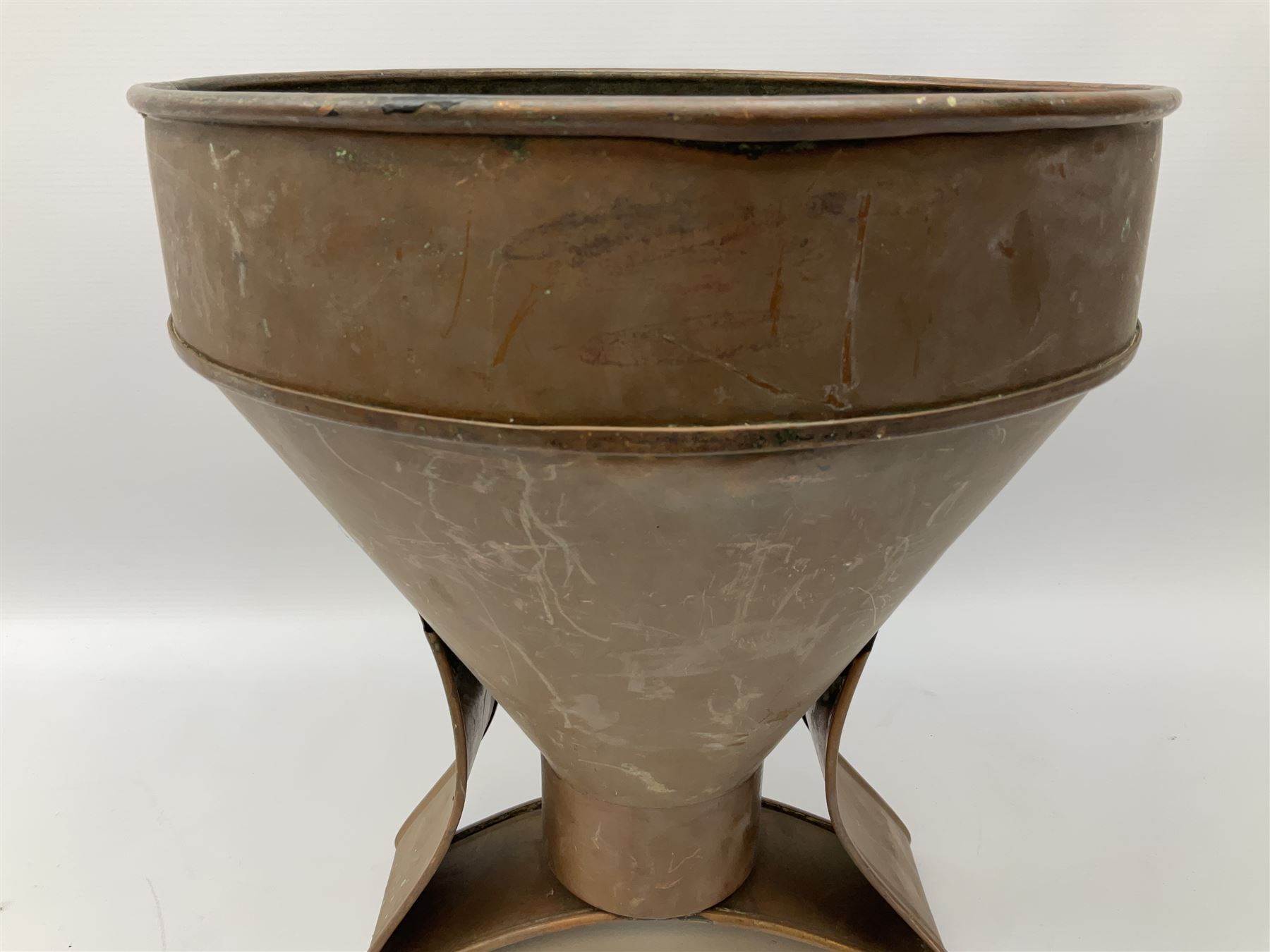 Agricultural copper corn funnel, H32.5cm, another similar copper funnel and copper warming platter of oval form, with twin handles on four supports, with removeable warming plate, L49cm