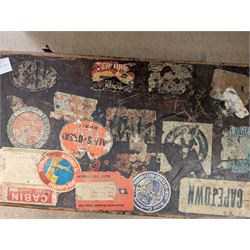Collection of books, including Art in Britain 1890-1940 from the collection of The University of Hull and The Humber by Anthony V Watts, housed within a leather suitcase decorated with various travel labels 