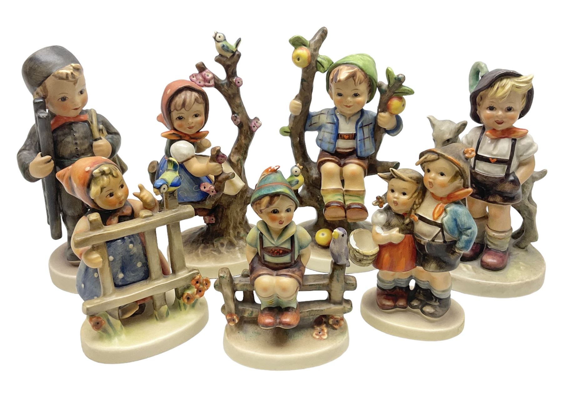Seven Goebel Hummel figures, comprising Chimney Sweep 12/I, Apple Tree Girl 14/I, Apple Tree Boy,  Little Goat Herder 200/I, Surprise 94 3/0, Signs of Spring 203/20 and Wayside Harmony 111/30, tallest H15cm