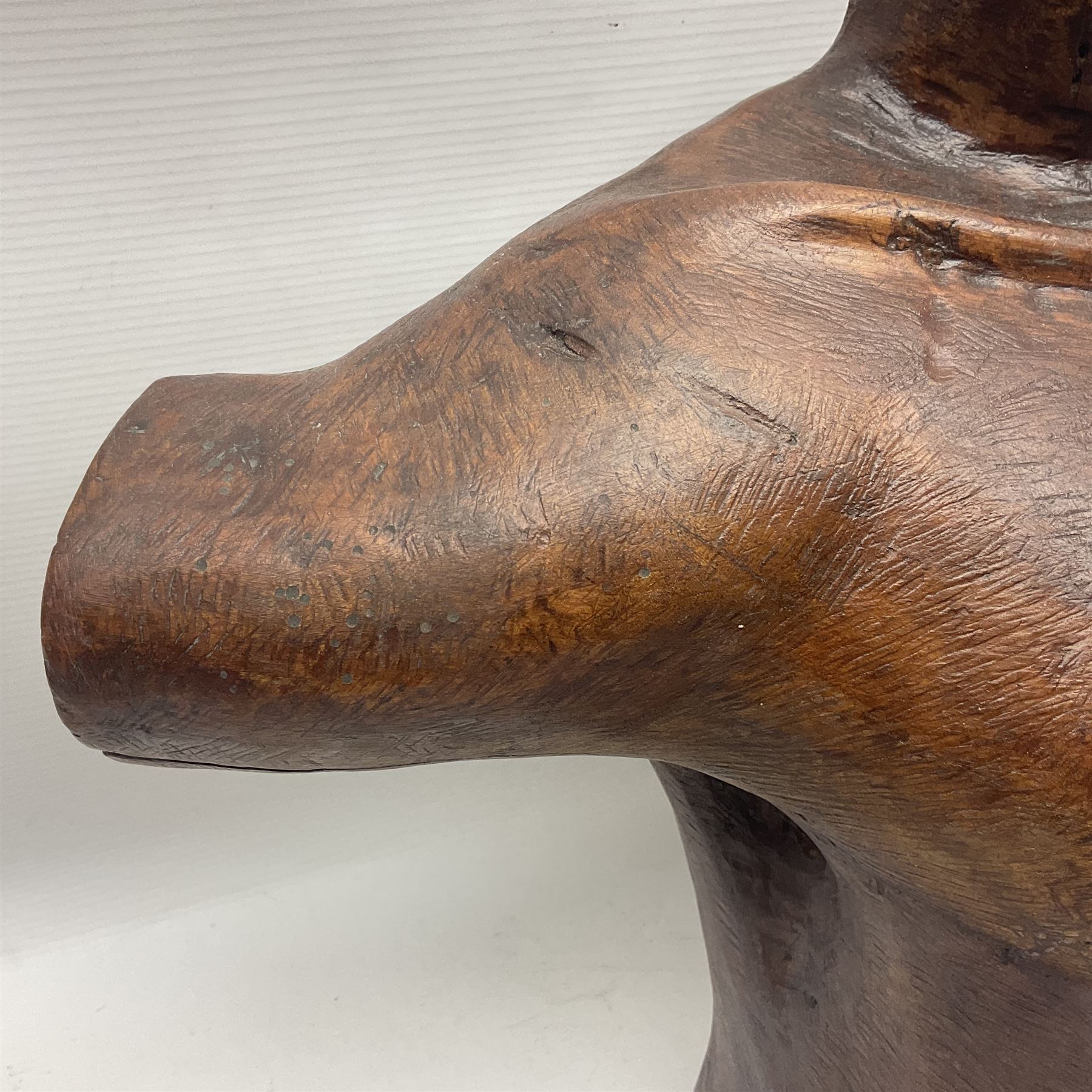 Helen Skelton (British 1933 – 2023): Large carved wooden sculpture, modelled as a male torso, H40cm. Born into an RAF family in 1933 in Kent and travelled the world extensively during her childhood. After settling in Bridlington, Helen immersed herself in painting, textiles, and wood sculpture, often inspired by nature's beauty. Her talent was showcased in a one-woman show at Sewerby Hall and recognised with the sculpture prize at Ferens Art Gallery in 2000. Sadly, Helen’s daughter passed away from cancer in 2005. This loss inspired Helen to donate her sculptures to Marie Curie upon her passing in 2023.