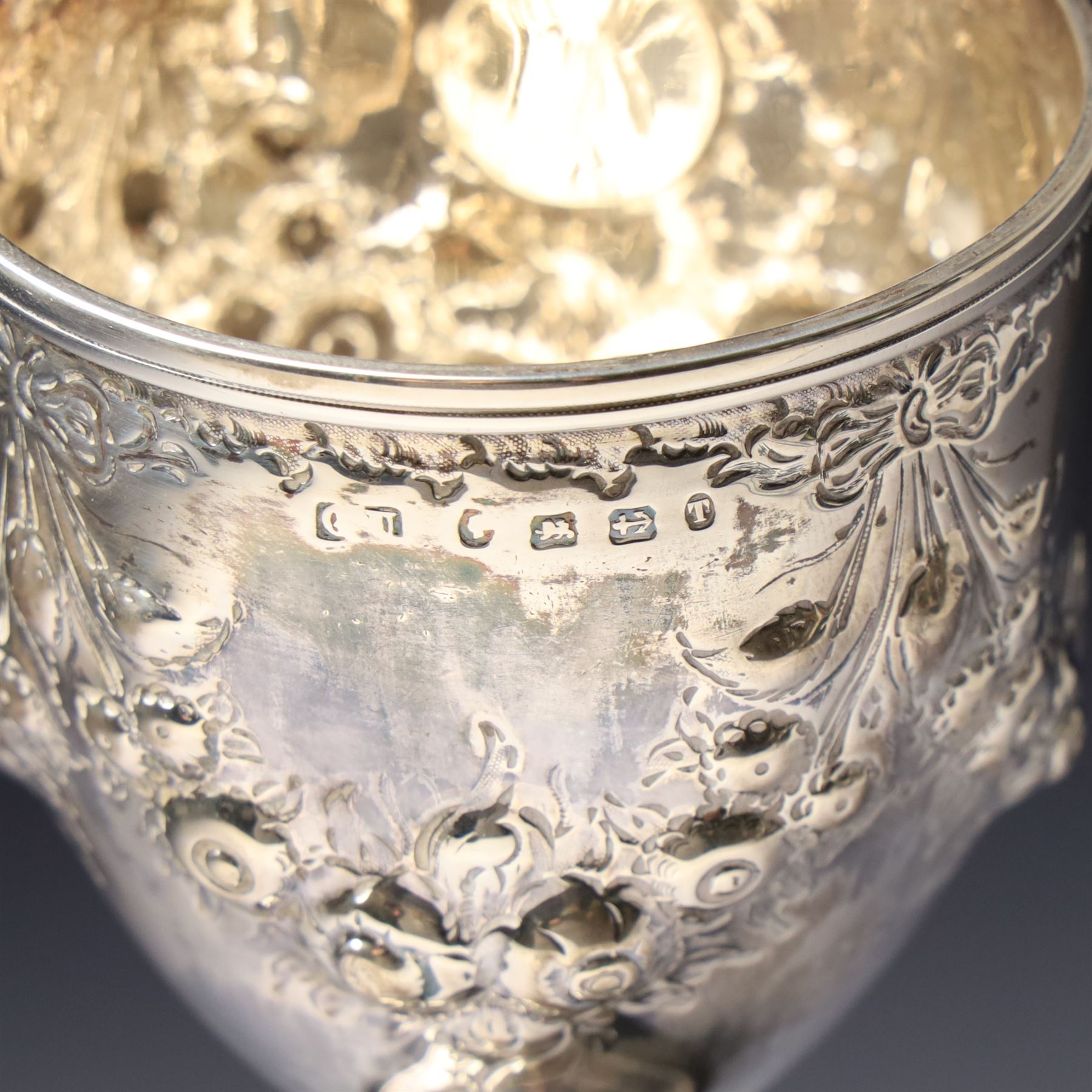 Victorian silver cup with embossed decoration on a plastic base, height of cup 16cm Birmingham 1868 and a small silver challenge cup 'Whitby Show 1950'
