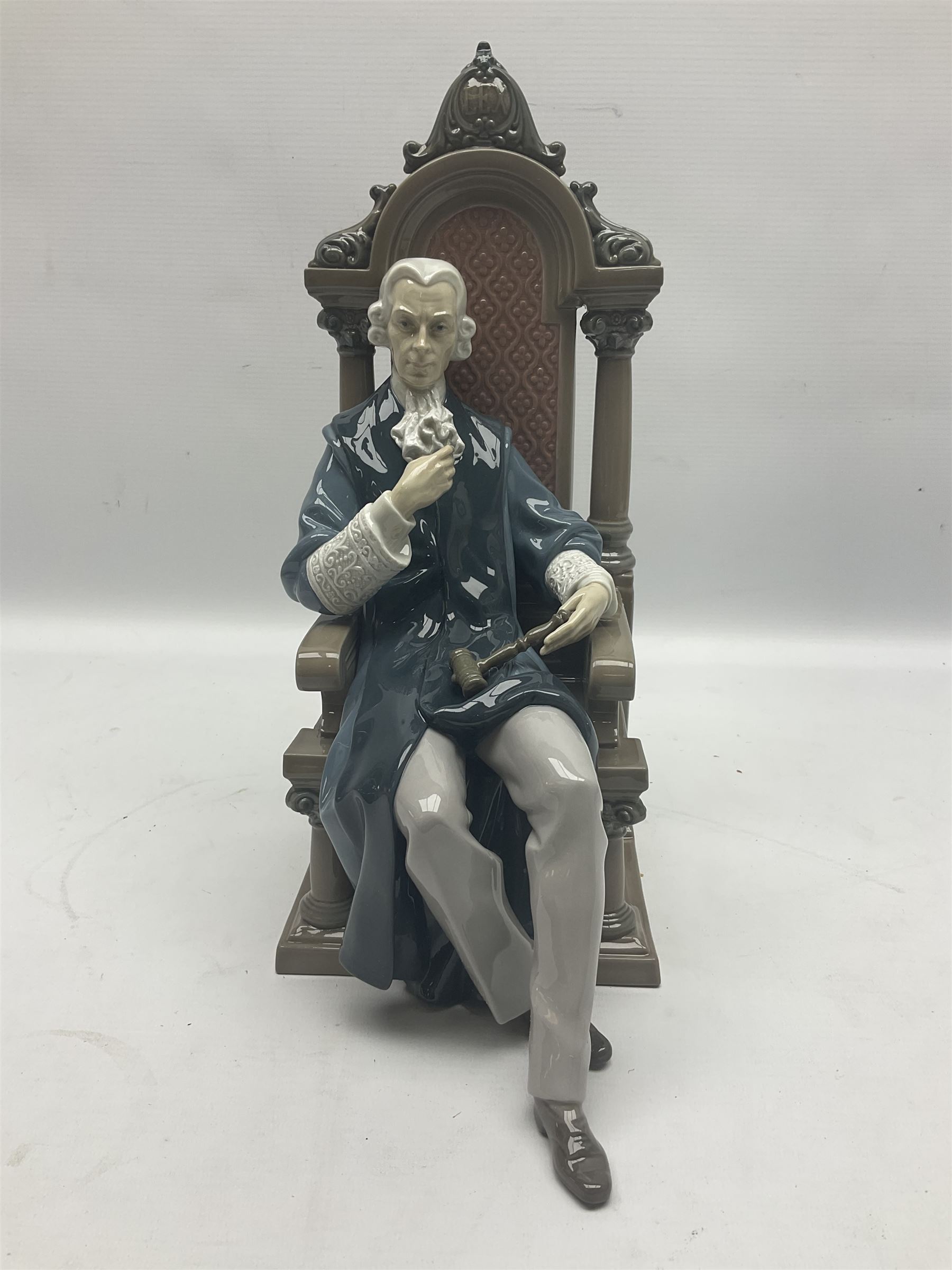 Lladro figure, Justice, modelled as a judge sat in a char, sculpted by Salvador Furió, with original box, no 5489, year issued 1988, year retired 1993, H34cm 