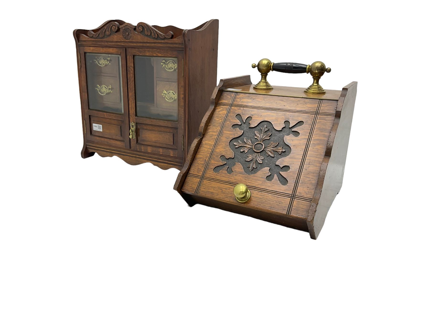 Edwardian oak smokers cabinet, broken swans neck pediment, two bevelled glazed and panelled doors enclosing four small drawers and pigeon hole (W42cm H45cm); Edwardian oak coal scuttle, carved fall-front with brass handles (W32cm H37cm)