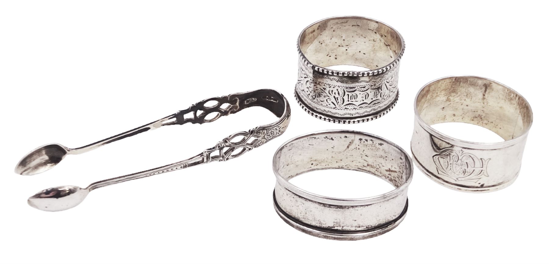 Pair of Victorian silver sugar tongs, with pierced decoration, hallmarked Hilliard & Thomason, Birmingham 1892, together with three hallmarked silver napkin rings