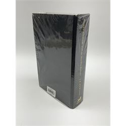 First Edition 'Harry Potter and the Deathly Hallows' by J.K. Rowling, partially sealed in plastic wrapper