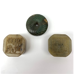 Two jadeite seals, carved with zoomorphic detail to one side and characters to the other, D5cm, together with a nephrite jade bi disc, D5.5cm. (3). 