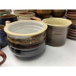 Wold studio pottery tankards, in various colours and relief decoration together with other studio items including vases, jugs and pots 