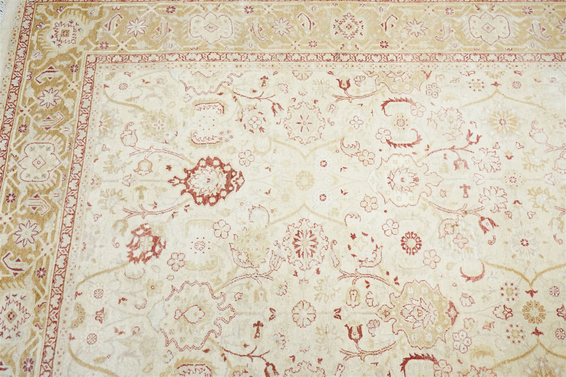 Modern Pakistani Oushak style wool hand-knotted carpet,  ivory field with an all-over scrolling floral vine design in soft tones of madder red and pale gold, enclosed by a conforming border, with cotton fringe ends  