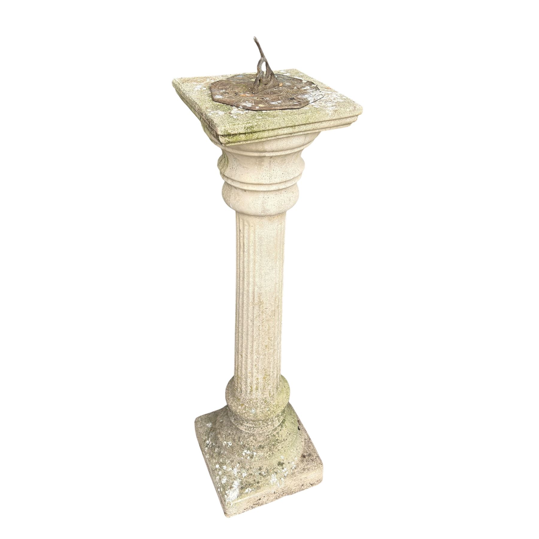 Weathered cast stone sundial on fluted pedestal