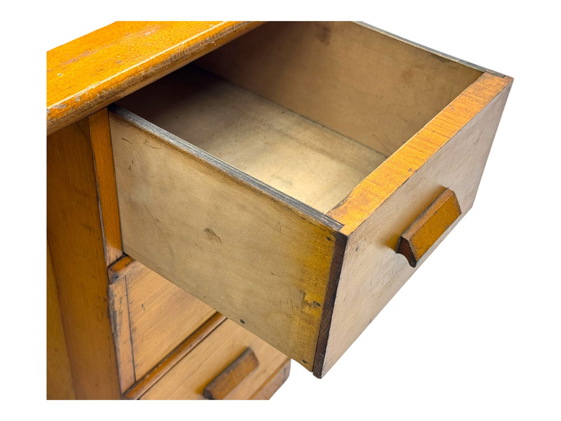 Leeway - late 19th century light oak child's roll-top desk, tambour top opening to reveal fitted interior with green felt writing surface and five pigeonholes, over three graduated drawers on the right side, raised on panelled side supports