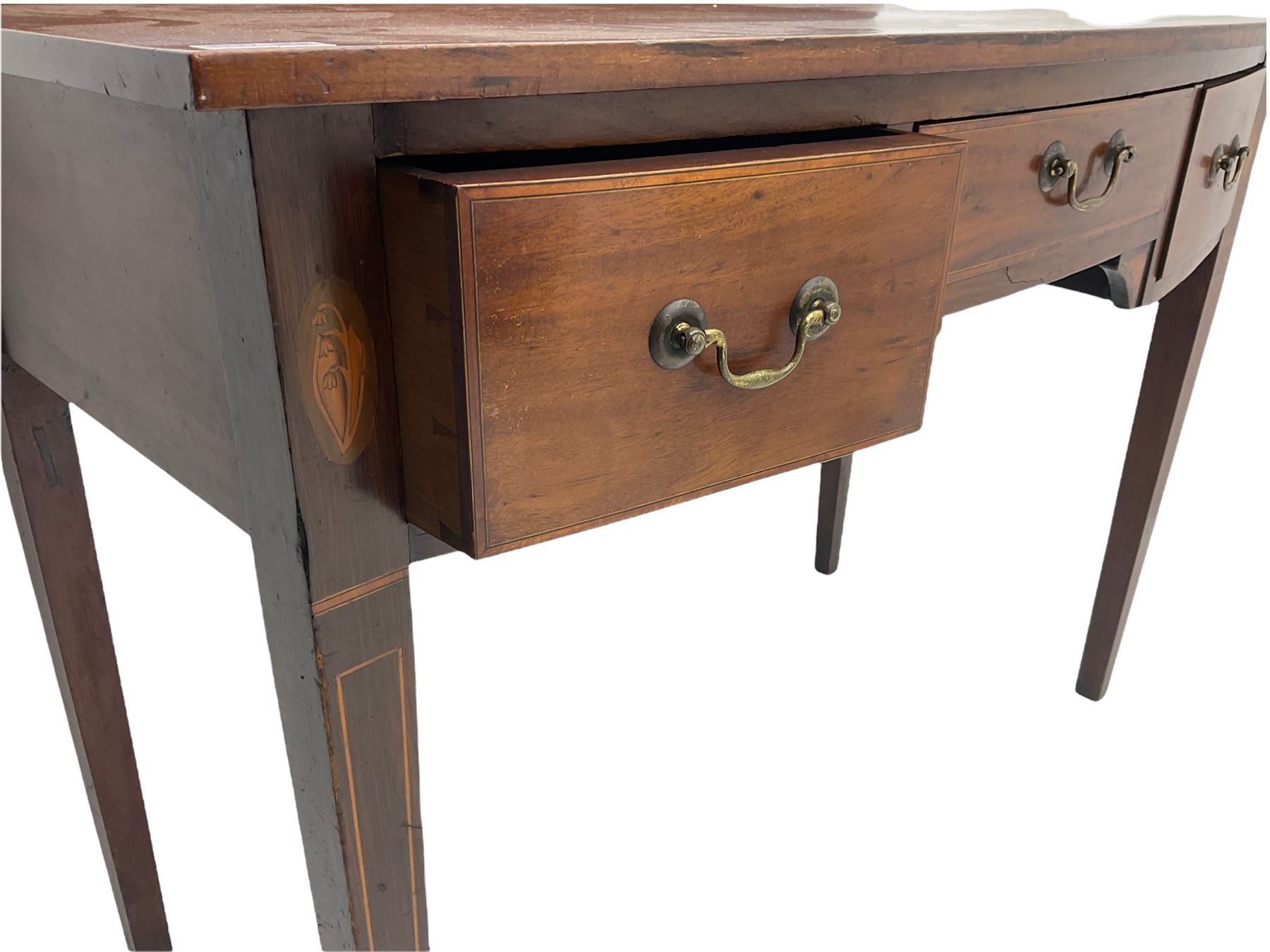 Edwardian mahogany dressing side table, raised back on bow front top with satinwood band, fitted with three drawers, inlaid with shell and fan motifs, square tapering supports
