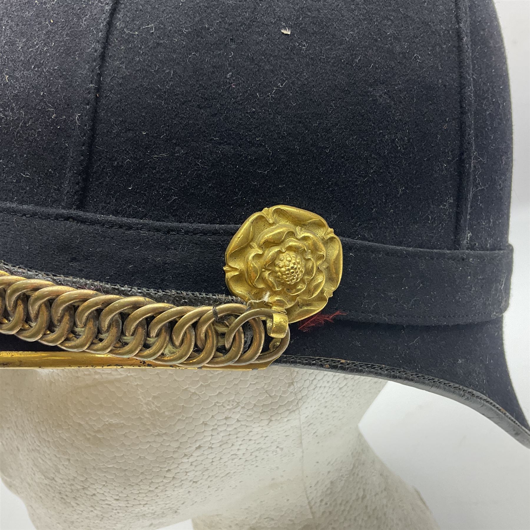 Late Victorian North Staffordshire Regiment Officer's Home Service Blue Cloth Helmet, having incorrect other ranks gilt metal Queen's crown helmet plate to the front with later leather backing, removable spike to the top on a shaped cruciform base with rosette fittings, rosette side bosses, brass trim to the front peak, and leather and velvet backed chin scales, with leather sweat band, the interior with makers stamp for Hawkes & Co 14 Piccadilly London