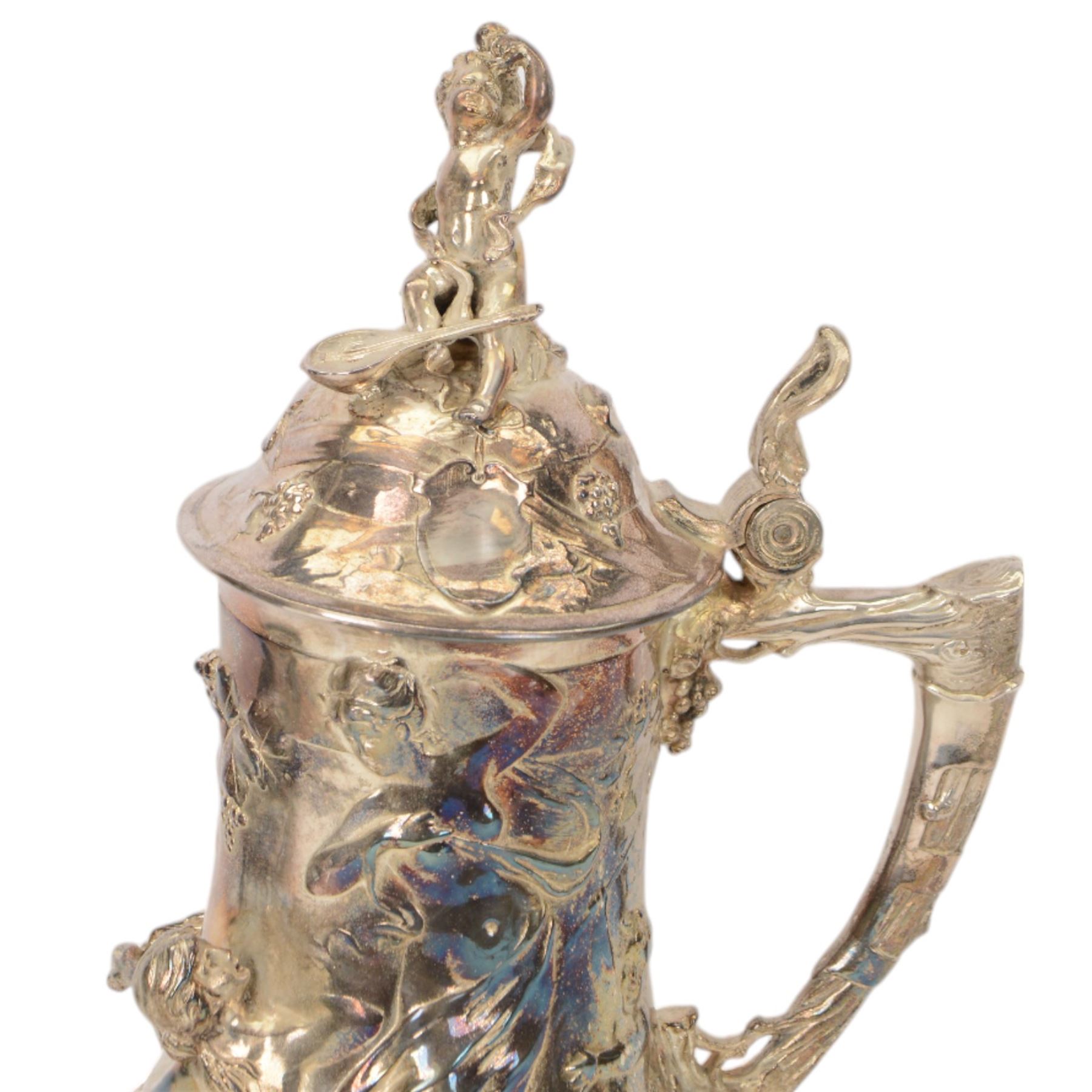 Large late 19th/early 20th century WMF Art Nouveau silver plated stein or jug, circa 1900, the bellied body cast and applied with Bacchanalian figures, the domed cover with putti finial, and handle modelled as a vine, the whole upon four fruit and leaf mounted feet, marked beneath for WMF and engraved with initials CHE and dated 1911, H40.5cm
