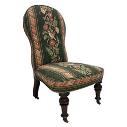 Victorian walnut nursing chair, turned front supports with brass and ceramic  castors, upholstered in floral patterned fabric