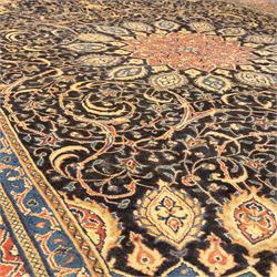 Large North West Persian Mahal hand-knotted carpet, central indigo field with a rosette medallion with an all-over design of scrolling vines and palmettes, framed by a brick red border of arabesques and flowerheads between sky blue and ivory guard stripes, with cotton fringe ends 