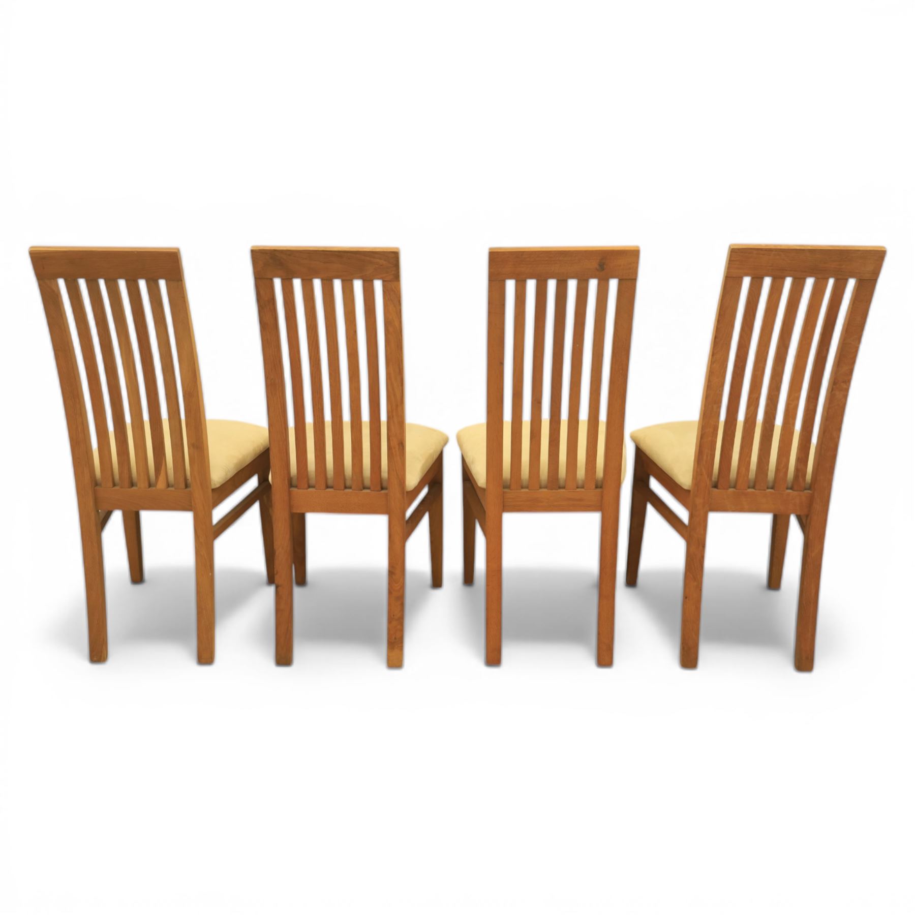 Contemporary teak dining suite comprising extending table and eight chairs, the table with rectangular plank top and one additional leaf extending to 210cm, supported on square tapering legs, the chairs with tall slatted backs and cream upholstered seats