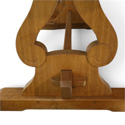 Acorn Industries - oak dining table, rectangular top with rounded corners and chamfered edge, raised on twin lyre-shaped supports united by pegged stretched on sledge feet, carved with acorn signature to stretcher, by Alan Grainger, Brandsby