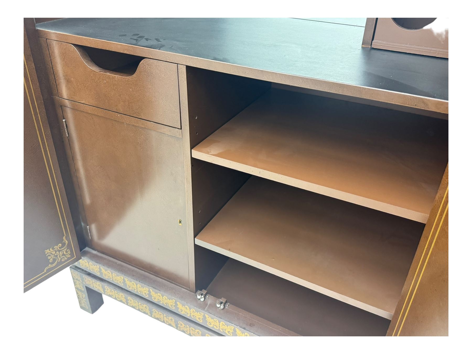 Chinese brown lacquered cocktail cabinet, decorated with gilt scenes of a traditional landscape with figures, pagodas, and mountainous scenery, double doors opening to reveal fitted interior with mirrored back, wine rack, shelves and cupboard, raised on square supports