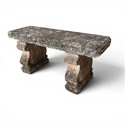 Weathered cast stone three-piece garden bench, with rectangular seat with egg-and-dart moulded edge, raised on end supports decorated with S-scrolls and fruiting vines