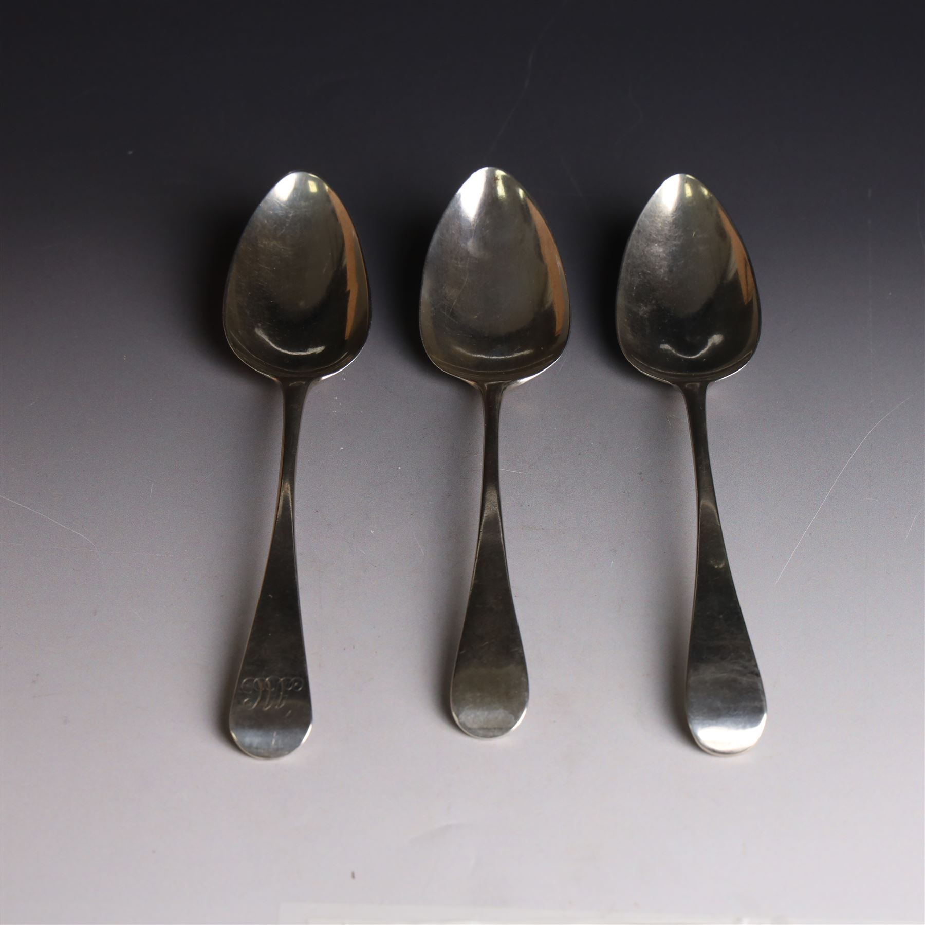 Three George III silver Old English pattern table spoons, one with engraved monogram to terminal, hallmarked Solomon Hougham, London 1802, a further example hallmarked London 1805, makers mark indistinct and one other hallmarked George Wintle, London 1807