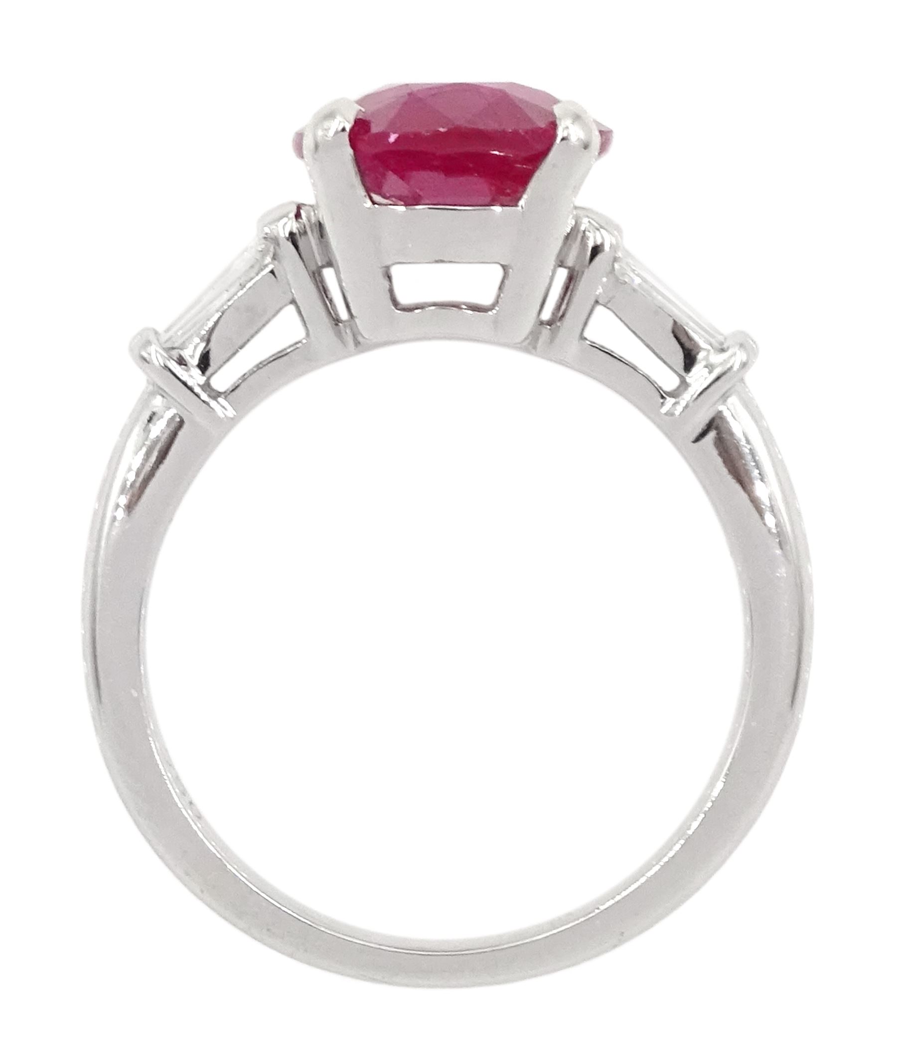 18ct white gold ruby and diamond ring, the oval cut ruby of 4.16 carat, with two tapered baguette cut diamonds set either side, hallmarked