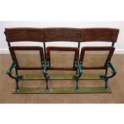  Early 20th century cast iron framed folding cinema seats, rush splat and seat, W152cm, H86cm, D40cm  