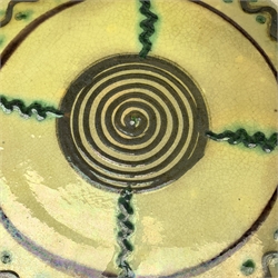 Vallauris Pottery wall plate or small charger, of circular form, the yellow ground with stylised decoration in green and brown, D31.5cm. 