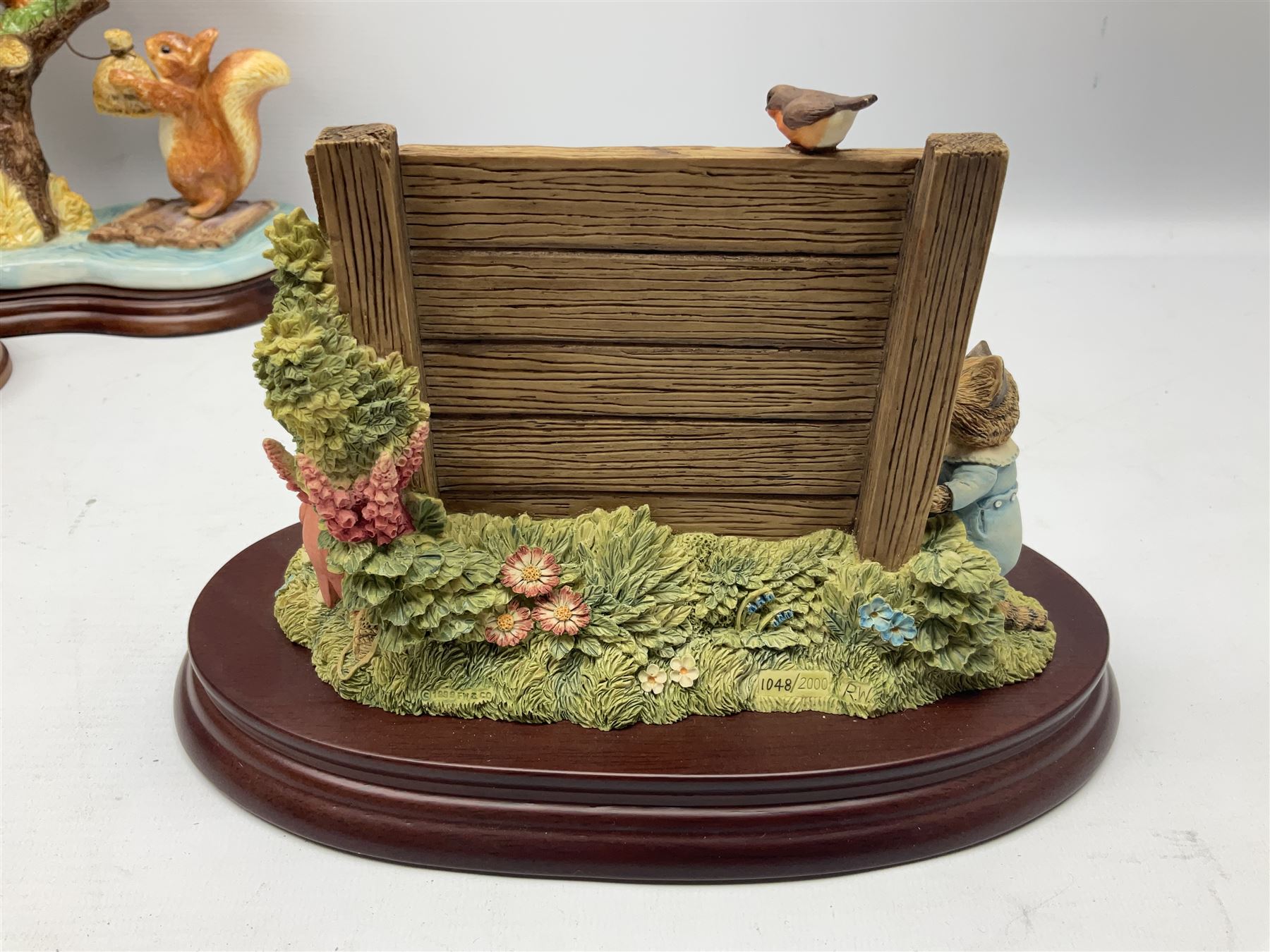 Four Border Fine Arts Beatrix Potter figures, comprising Tableau created to commemorate the Millenium together with a Border Fine Arts Limited Edition no 669814, The Tale of Peter Rabbit Tablet A1306, Four Little Rabbits A2442 and Sailing Home A2443