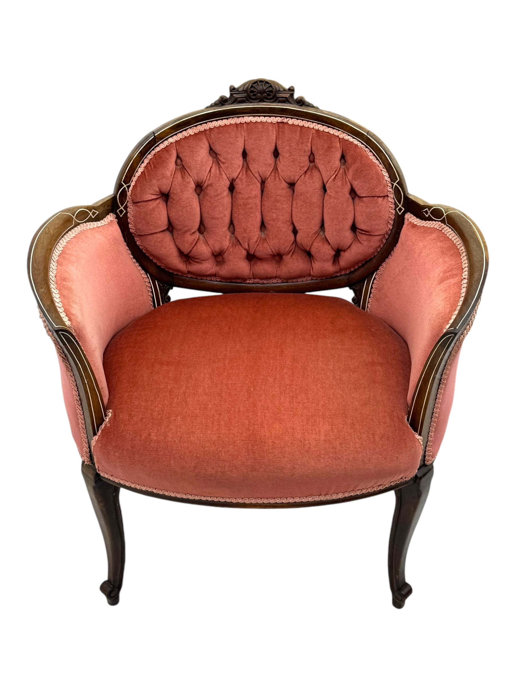 Edwardian inlaid rosewood parlour suite, comprising pair of tub shaped armchairs (W77cm, D69cm, H88cm); and matching two-seat sofa (W112cm, D69cm, H88cm), each with carved crest rails with shell motifs, deep button-tufted oval backs upholstered in pink fabric with braid trim, on cabriole supports