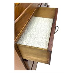 Early 19th century mahogany linen press cupboard, projecting moulded cornice over figured frieze, two panelled doors enclosing shelves, fitted with two short and two long cock-beaded drawers, on bracket feet 