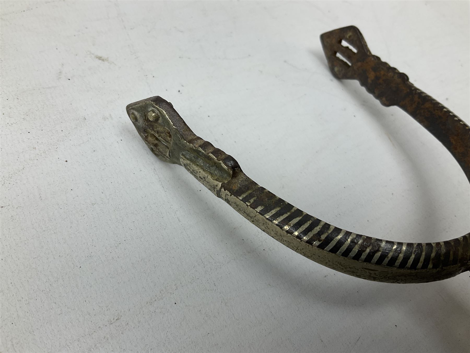 Pair of late 19th century South American iron spurs, engraved silver mounts, with sunburst rowls