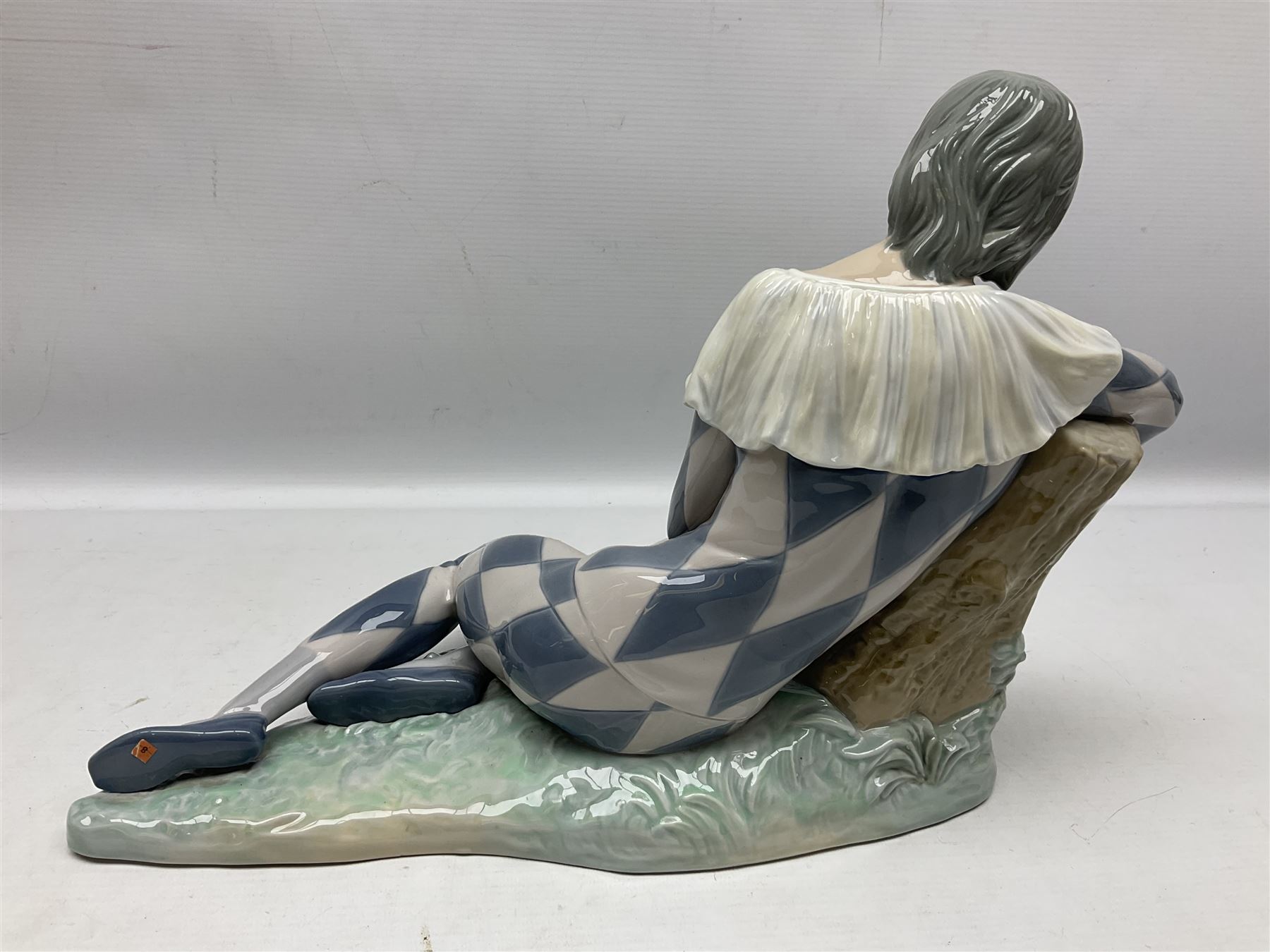 Lladro figure, Harlequin Reclining, modelled as a recumbent harlequin, no 5128, Sculpted by Salvador Furio, year issued 1982, year retired 1987, H28cm 